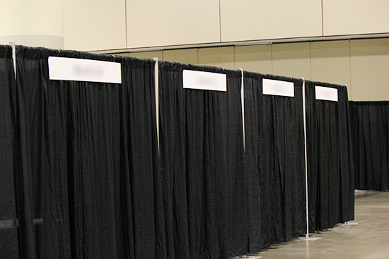 Private interview booths are 8'x8' curtained spaces with three chairs and a 4' table.