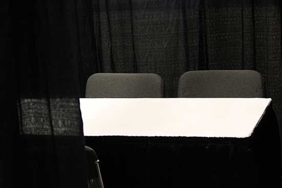 Private interview booths are 8'x8' curtained spaces with three chairs and a 4' table.