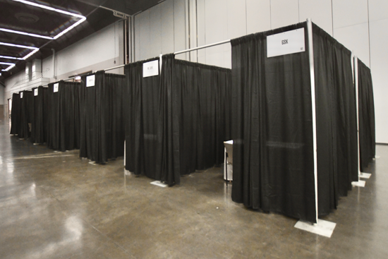 Private interview booths are 8'x8' curtained spaces with three chairs and a 4' table.